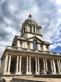 Low angle view of historical building against cloudy sky