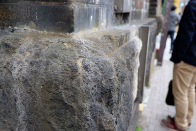 High angle view of sidewalk by stone wall
