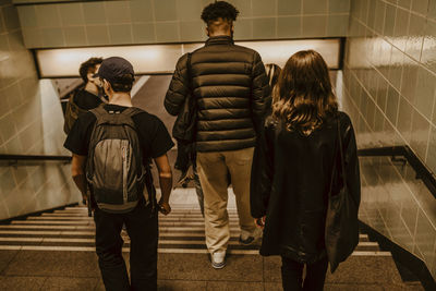 Rear view of people walking in corridor