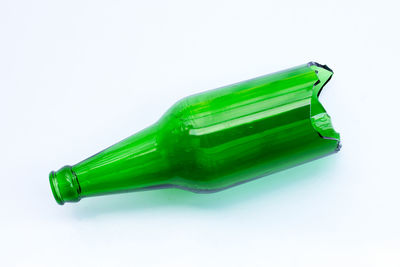 High angle view of green bottle on white background