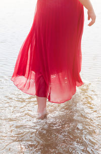 Low section of woman standing on beach