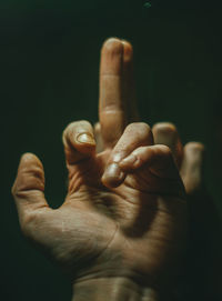 Close-up of human hand against black background