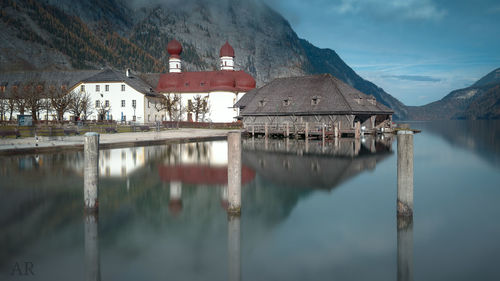 Scenic view of lake by building against sky