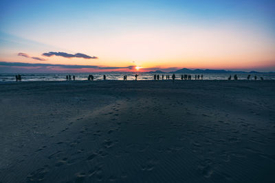 Scenic view of beach against sky during sunset