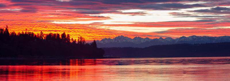 Scenic view of lake against orange sky