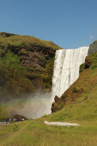 Scenic view of waterfall against sky