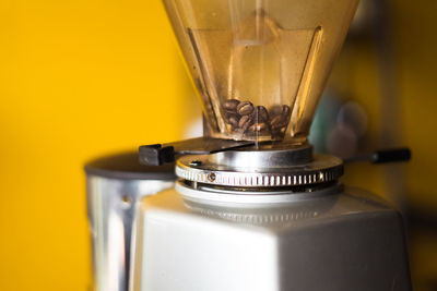 Close-up of coffee beans in machine.