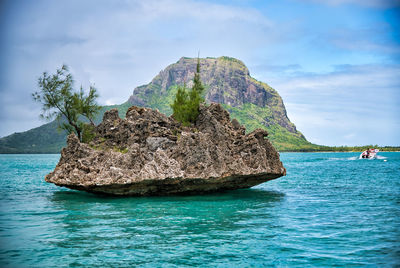 Rock formations in sea against sky