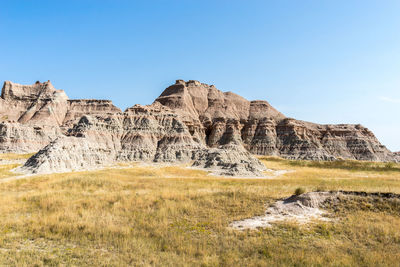 Rock formations on landscape against clear sky