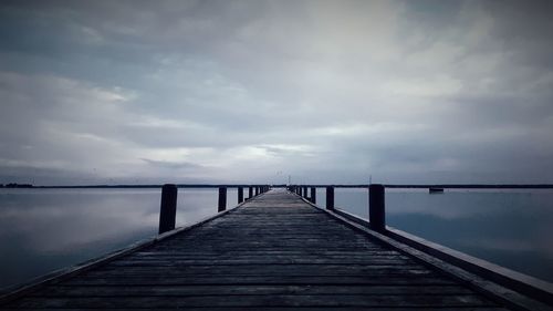 Pier over sea against sky