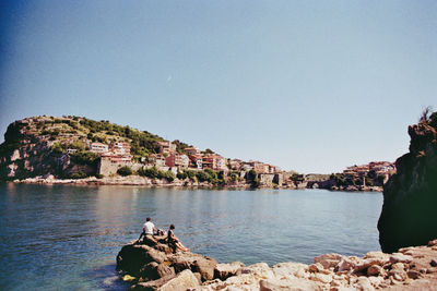 Scenic view of bay against clear sky