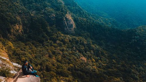 High angle view of man sitting on mountain