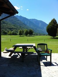 Empty chairs and table against mountain range
