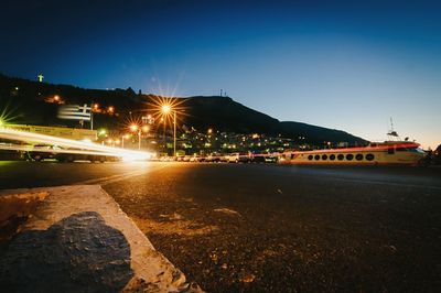 Illuminated street light against clear sky