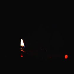 Close-up of illuminated lamp in darkroom