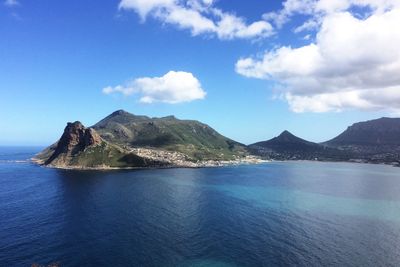 Scenic view of sea and mountains against sky