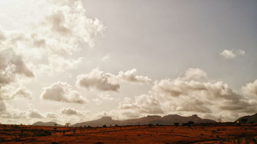 Scenic view of landscape against cloudy sky