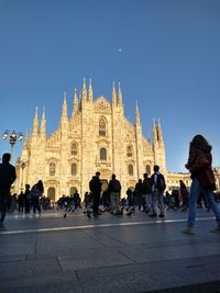 Group of people in temple against clear sky