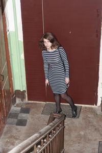 High angle view of woman standing at doorway