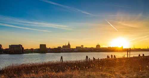 Buildings in city during sunset