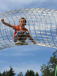 Low angle view of boy against sky