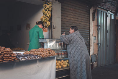 People working at market stall