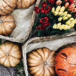 High angle view of pumpkins in container for sale at market stall