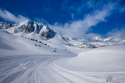 Scenic view of snow covered mountains against sky