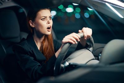 Shocked woman in car