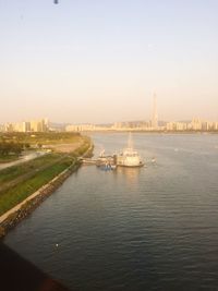 Boats in river with buildings in background