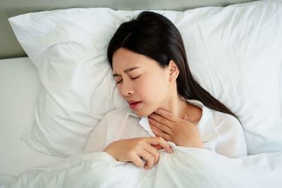 Young woman sleeping on bed