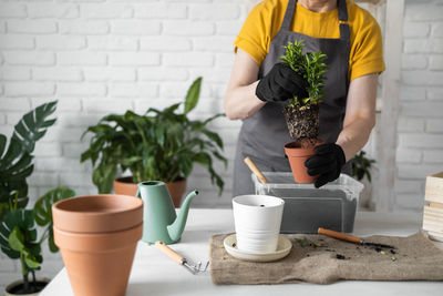 Midsection of man working on table