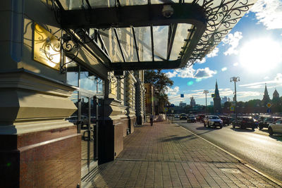 Footpath in city against sky