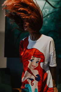 Rear view of girl standing at home
