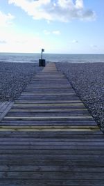 Pier over sea against sky