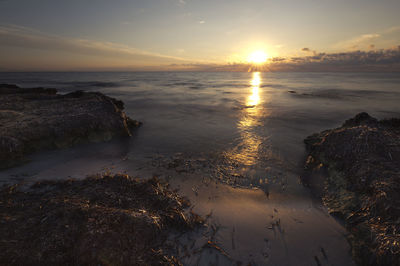 Scenic view of sea against sky during sunset