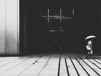 Woman standing by wall