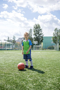 Boy playing soccer on field