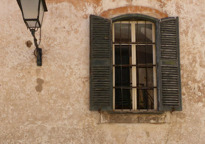 Low angle view of window on wall of building