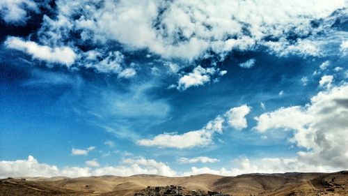 Scenic view of landscape against cloudy sky