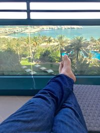 Low section of man relaxing on window