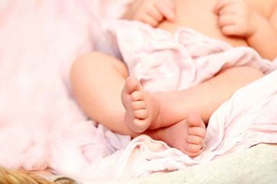 Close-up of baby on bed