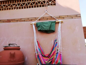 Close-up of clothes hanging on built structure