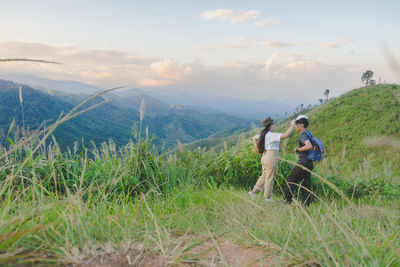 Rear view of woman standing on mountain