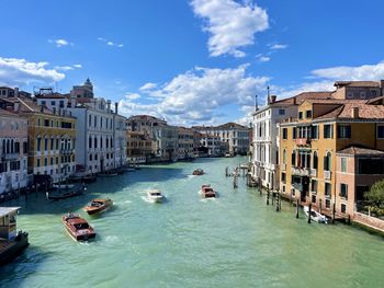 Boats in canal against sky