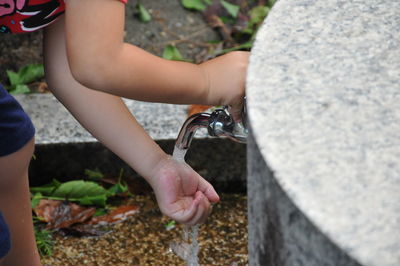 Cropped hand of man washing hands