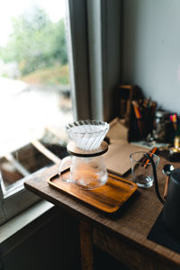 Coffee cup on table against window