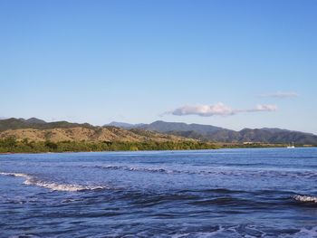 Scenic view of sea against clear blue sky