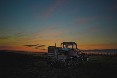 View of agricultural field against sky during sunset