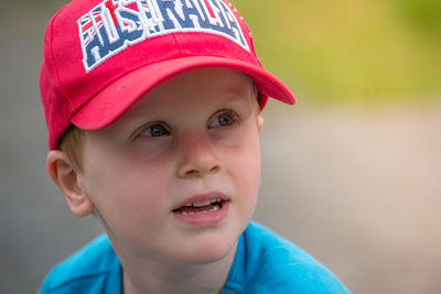 Close-up of thoughtful boy wearing red cap